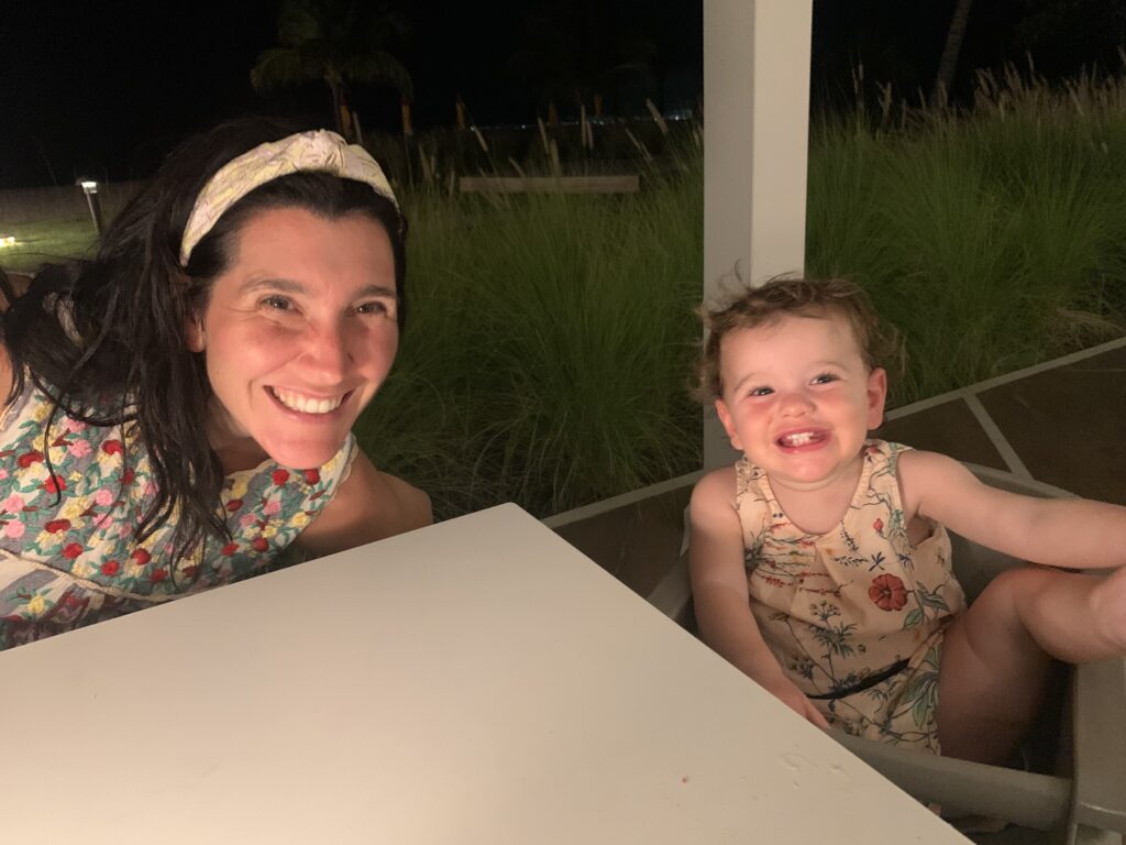 Mother and daughter smiling at dinner
