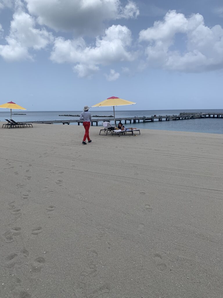 A person walking towards a beach chair.